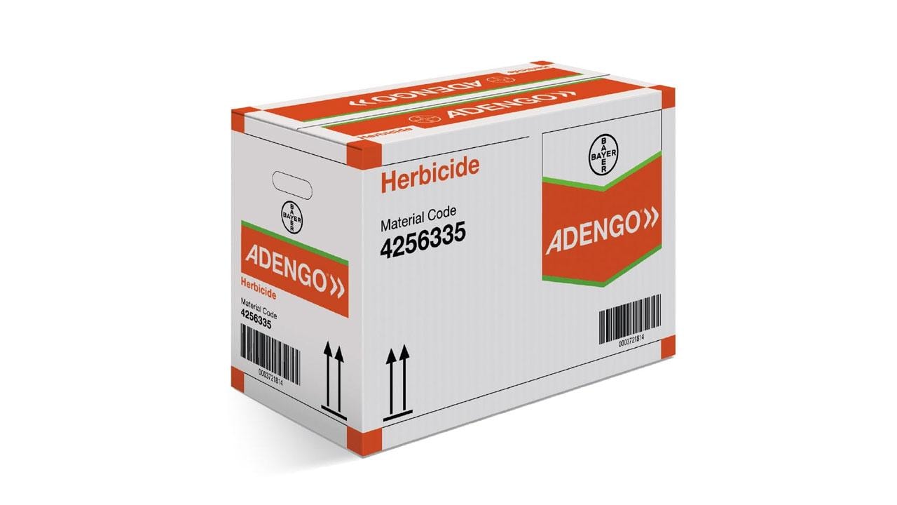 A cardboard box labeled "Adengo Herbicide" with a material code 4256335 and Bayer logo. The box features red and orange colors and handling symbols, including arrows.