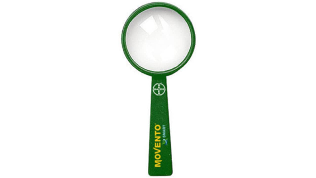 A green Movento magnifying glass with a handle, featuring a logo and text in yellow.