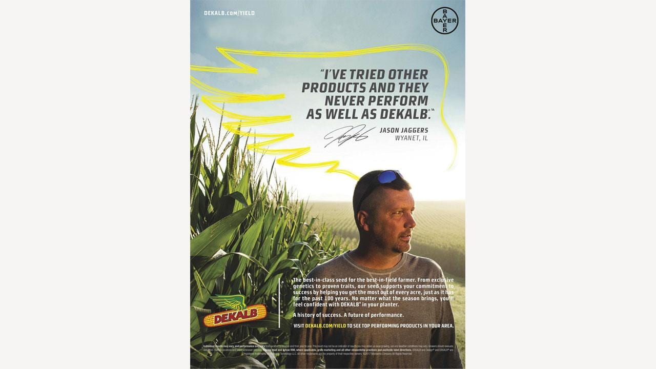 A man wearing a cap stands in a cornfield at sunset. A quote about DEKALB seed performance is displayed prominently in the sky.