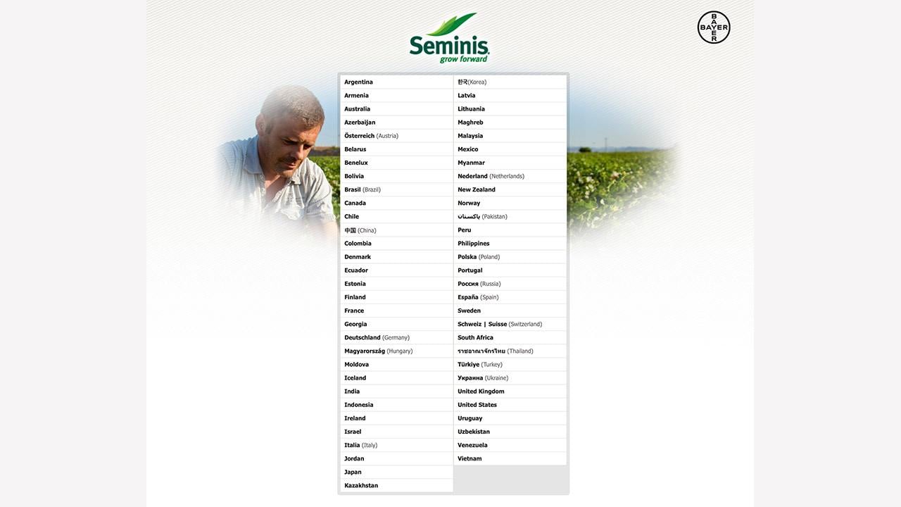 Seminis website homepage displaying a list of countries and regions with a background image of crops and a person on the side.
