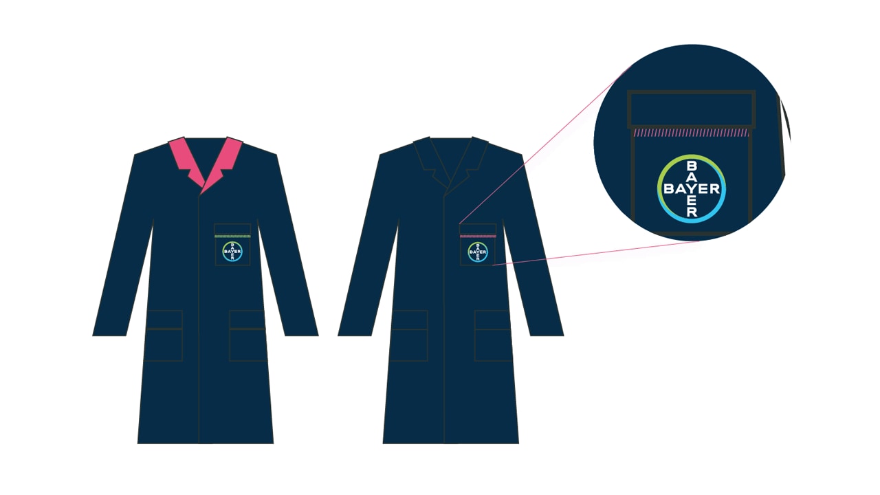 Two lab coats with Bayer logos on the chest. One has a pink collar. A close-up shows a logo detail on the back.
