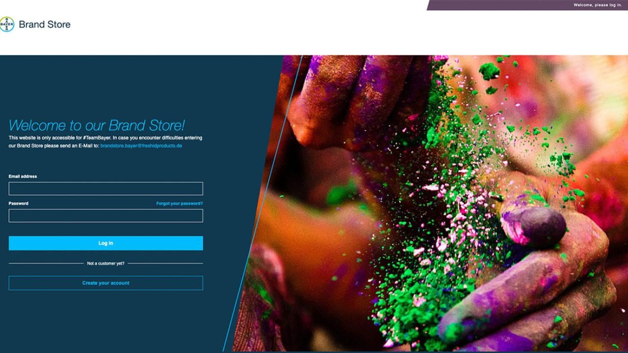 Login page for a brand store, with vibrant colored powders in hands on the right and login fields on the left.