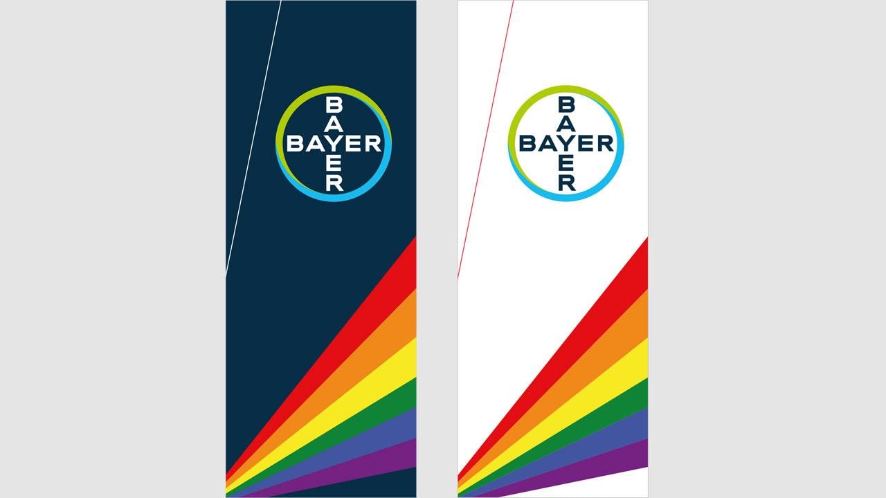 Two vertical banners with the Bayer logo at the top, featuring rainbow-colored stripes emanating from the bottom corner on dark blue and white backgrounds.
