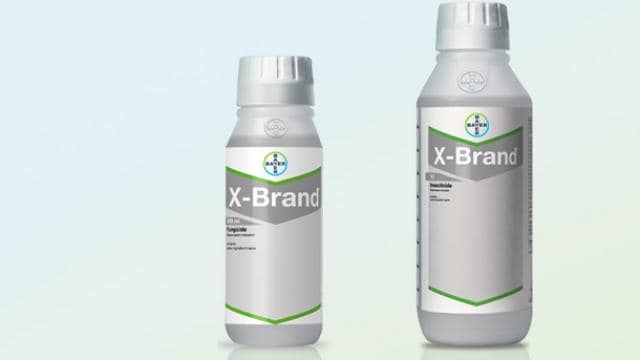 Two bottles of X-Brand pesticide with silver caps and green accents on a light blue background.