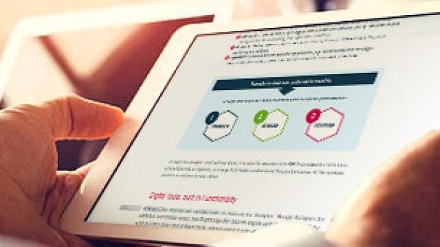 Person holding a tablet displaying a document with a diagram and text in a business setting.