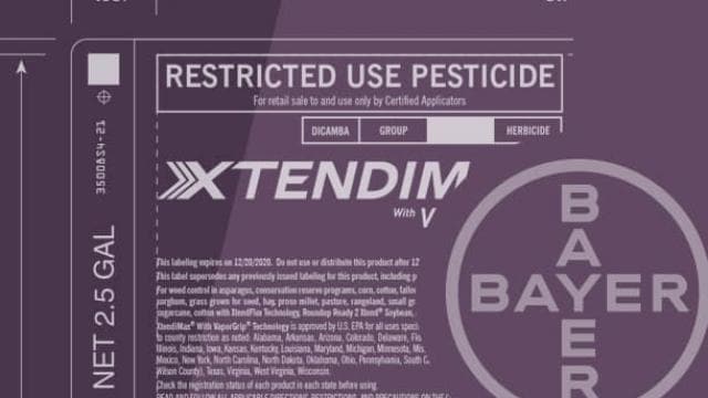 Label for Xtendim with V, a restricted use pesticide by Bayer, showing usage details and safety information.