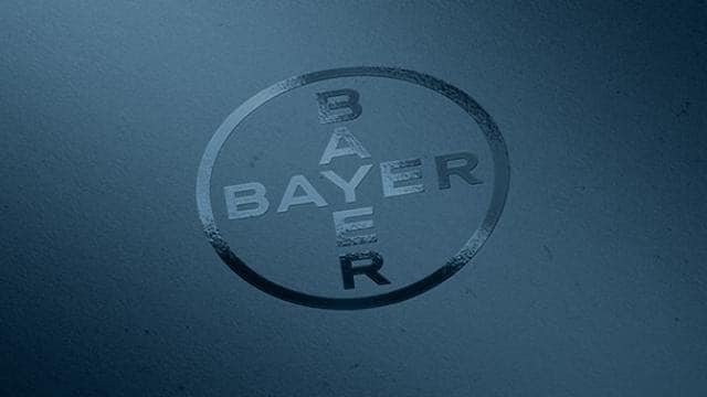 Bayer logo embossed on a dark blue surface.