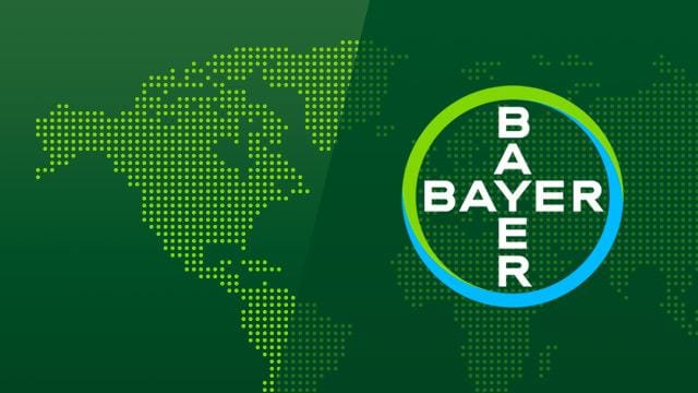 Bayer logo overlaid on a digital representation of a world map in green tones.