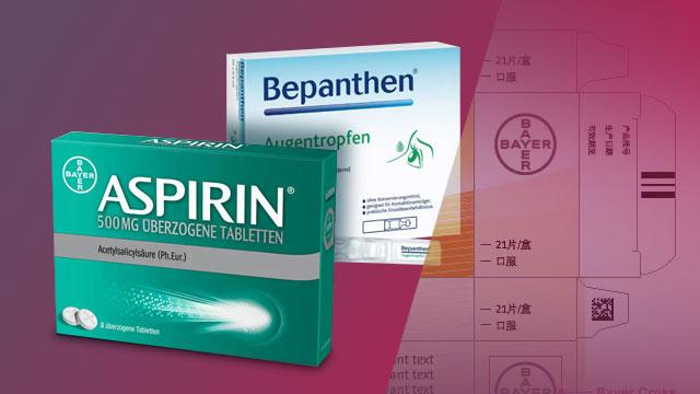 Packaging of Bayer products, including boxes of Aspirin and Bepanthen eye drops, displayed against a gradient background.