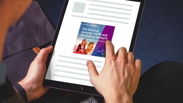 Person holding a tablet displaying an article titled "The future of everyday health and the science behind it.