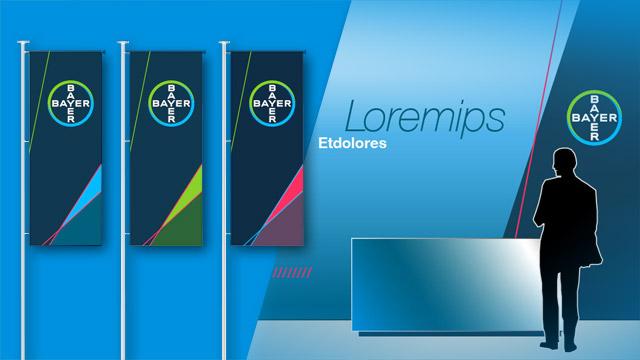 A silhouette of a person stands at a desk in front of three banners with Bayer logos and abstract designs. "Loremips Etdolores" text is visible on the wall in the background.
