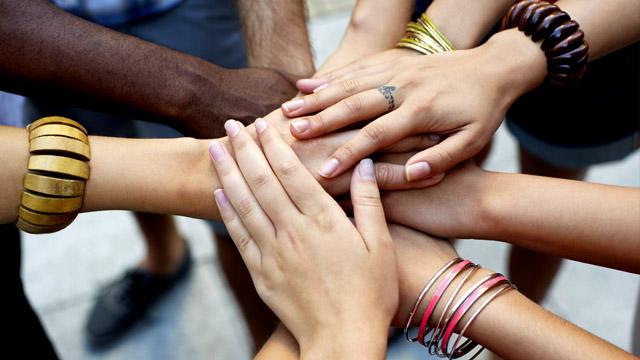 many hands placed on top of each other