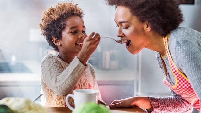 Son feeds mother 