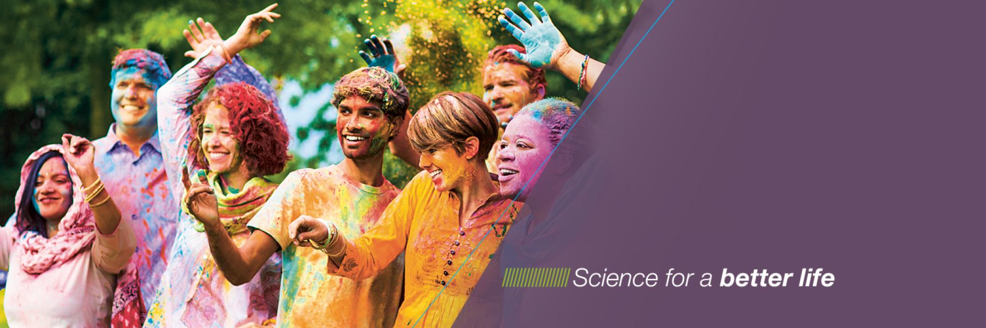 Group of people sprinkled with colored powder, Science for a better life
