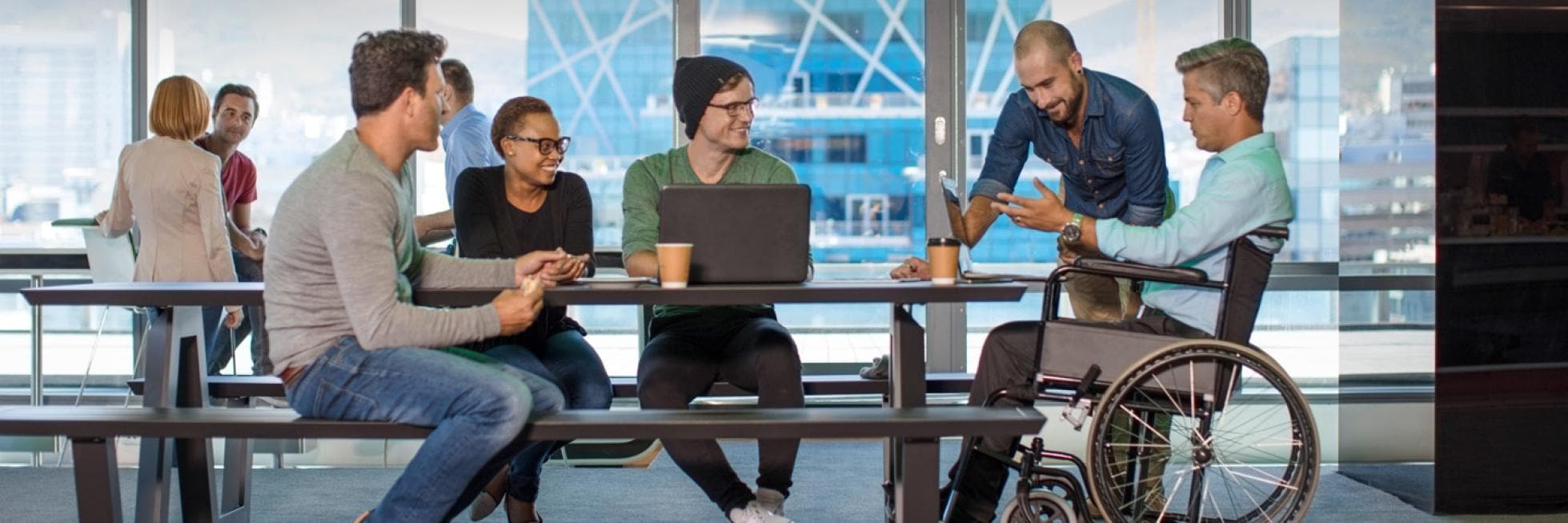 Group of people around a table, one person is in a wheelchair