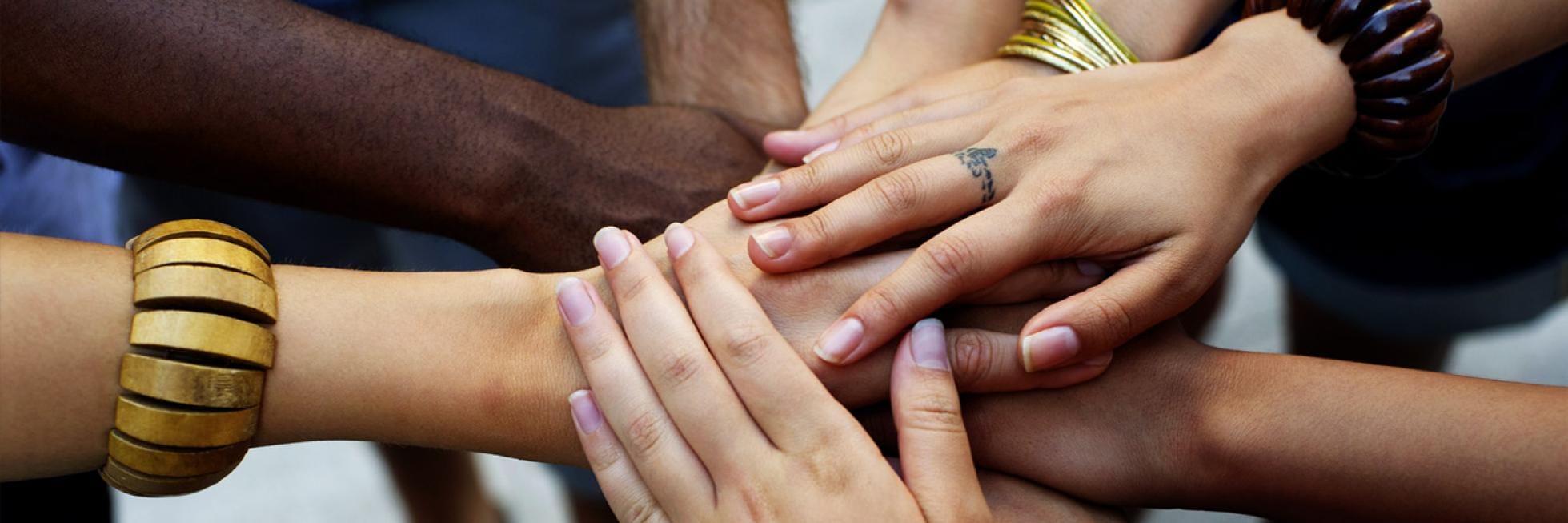 many hands placed on top of each other