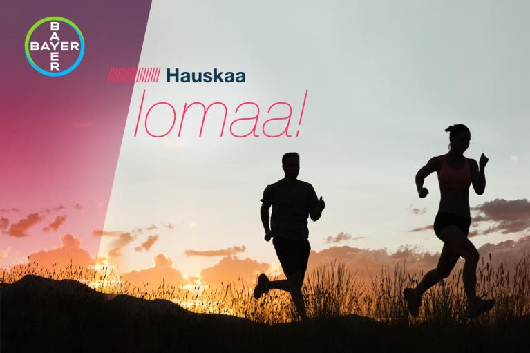 Silhouettes of a man and woman jogging at sunset with "Hauskaa lomaa!" and a Bayer logo in the corner.