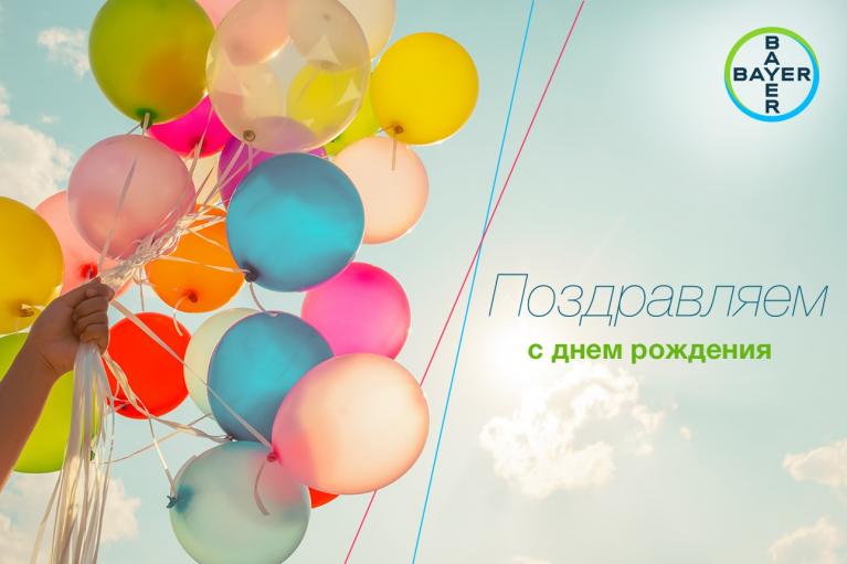 Colorful balloons floating in the sky with a "Happy Birthday" message in Russian and the Bayer logo in the top right corner.