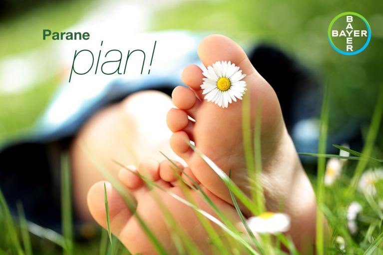 Close-up of bare feet in grass with a daisy on the toes. "Parane pian!" text and Bayer logo in the top right corner.