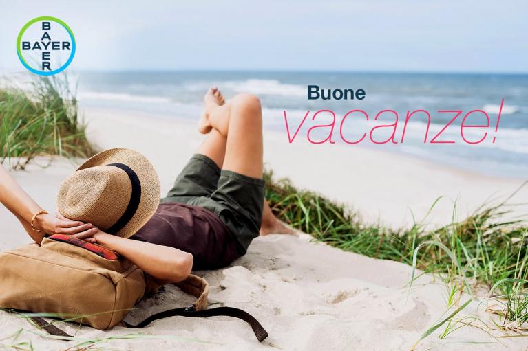 Person relaxing on a beach with a hat, backpack, and the text "Buone vacanze!" with Bayer logo in the corner.