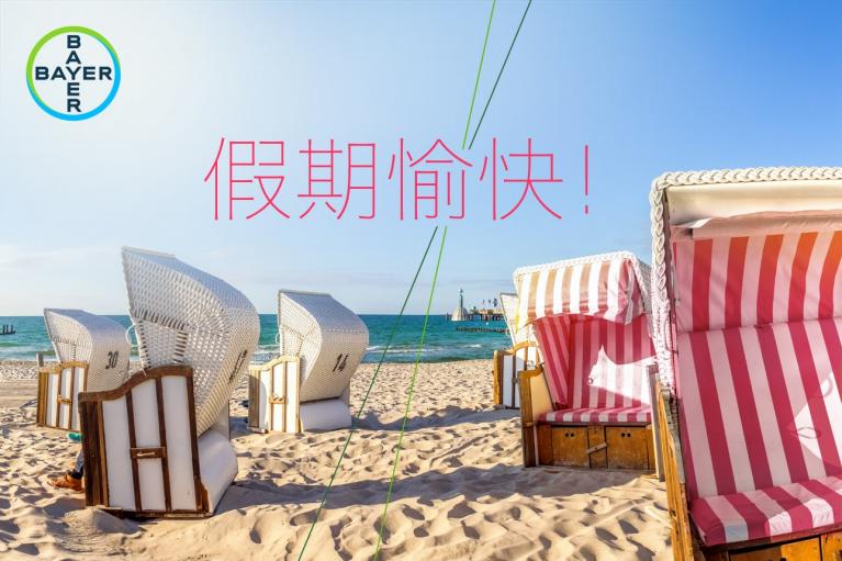 Beach scene with wicker beach chairs and a striped canopy chair on sand. Text in Chinese reads "Happy Holidays!" Bayer logo in the top left corner.