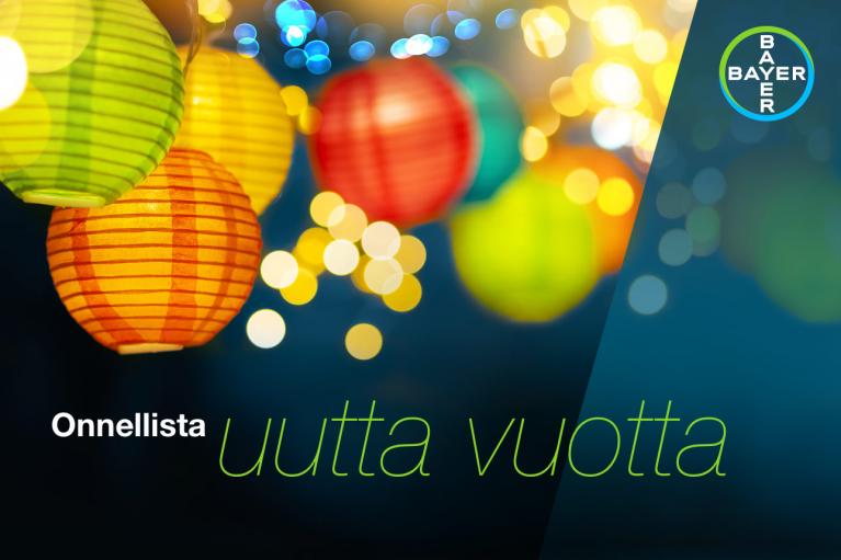 Colorful paper lanterns with glowing lights are set against a dark background. The text reads "Onnellista uutta vuotta" and features the Bayer logo in the top right corner.