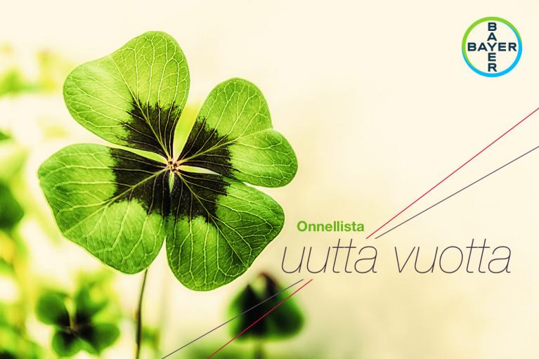 A four-leaf clover with a Bayer logo. Finnish text reads "Onnellista uutta vuotta," which means "Happy New Year.