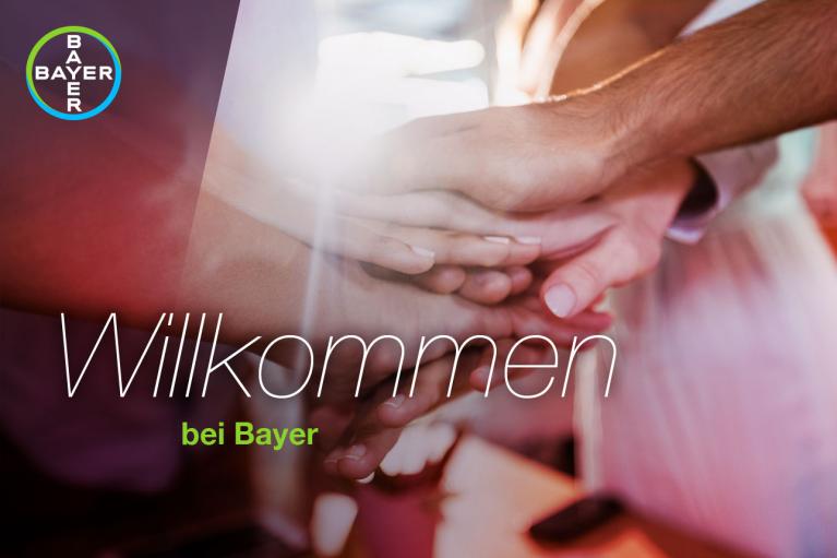 Hands stacked together with "Willkommen bei Bayer" text overlaid, and Bayer logo in the top left corner.