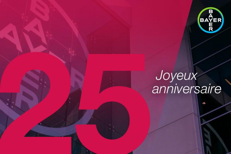 Red and black design with the number 25 and "Joyeux anniversaire" text overlay on a building with Bayer logo.