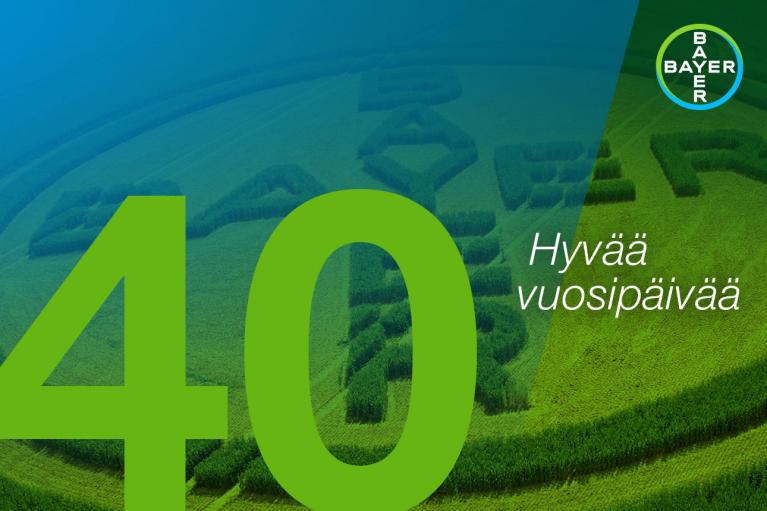 Green field with a large "40" and "Hyvää vuosipäivää" text overlay; Bayer logo in the top right corner.