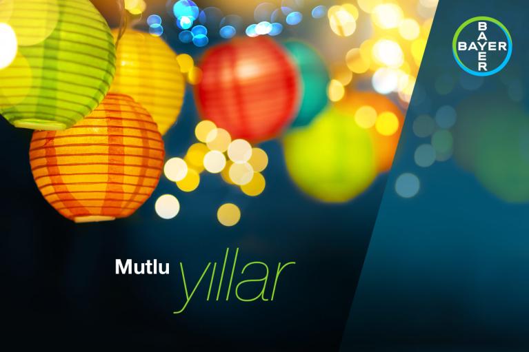 Colorful paper lanterns with bokeh lights in the background and "Mutlu yıllar" text. Bayer logo in the top right corner.