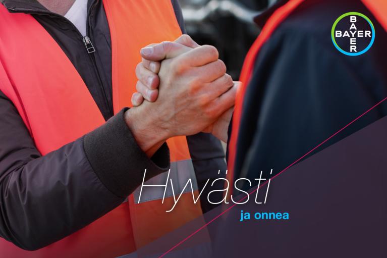 Two people in orange vests shake hands. The text "Hyvästi ja onnea" is overlaid, and a Bayer logo is visible in the top right corner.