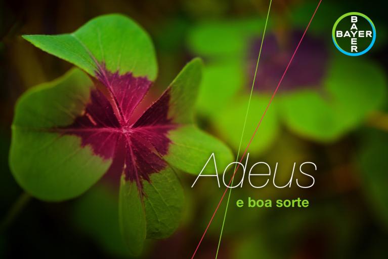 A close-up of a clover with "Adeus e boa sorte" text and a Bayer logo.