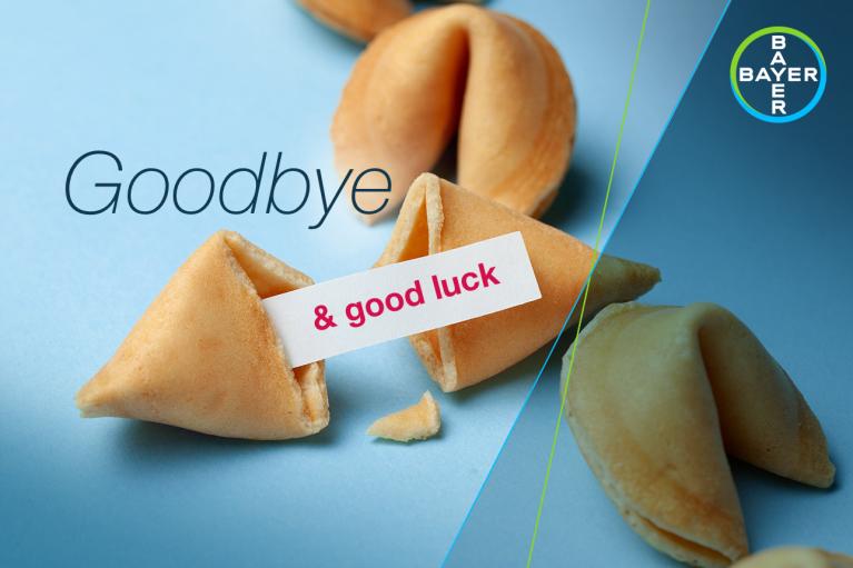 Fortune cookie partially opened with a slip saying "& good luck" next to the word "Goodbye" on a blue background. Bayer logo in the corner.