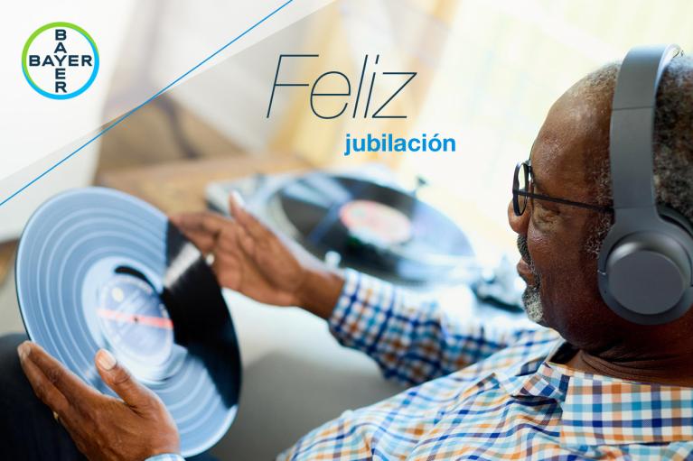 An older man with headphones holds a vinyl record. Text reads "Feliz jubilación" beside a Bayer logo.