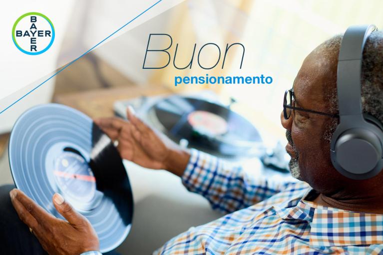 An older person with headphones holds a vinyl record. Text reads "Buon pensionamento" and features the Bayer logo.
