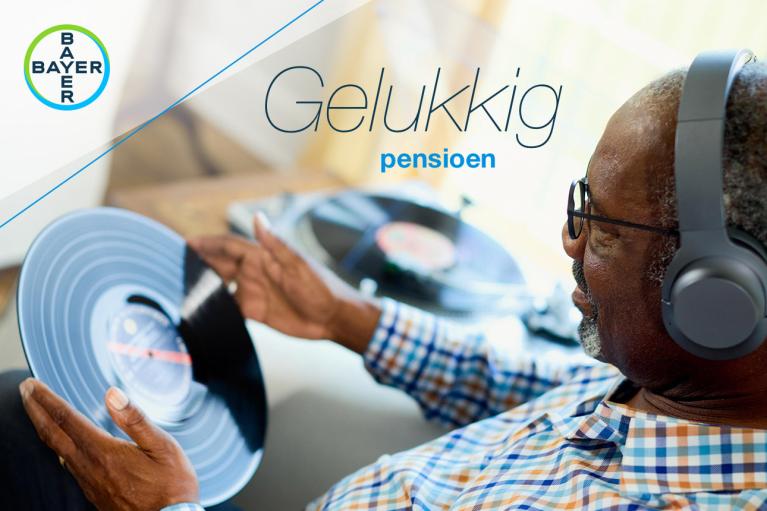 An older man wearing headphones holds a vinyl record and sits by a turntable. The text reads "Gelukkig pensioen" and features the Bayer logo in the corner.