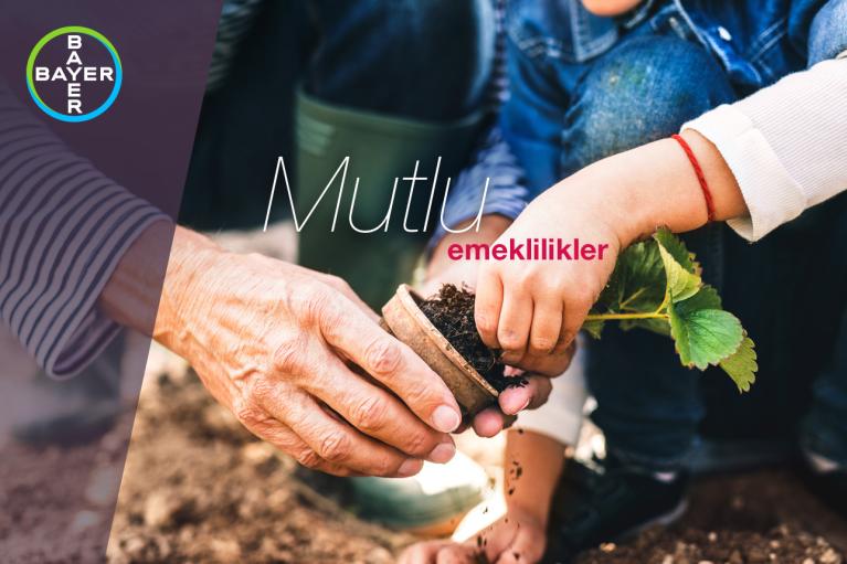 Two people planting a small plant in a pot with soil, featuring the Bayer logo and the text "Mutlu emeklilikler.