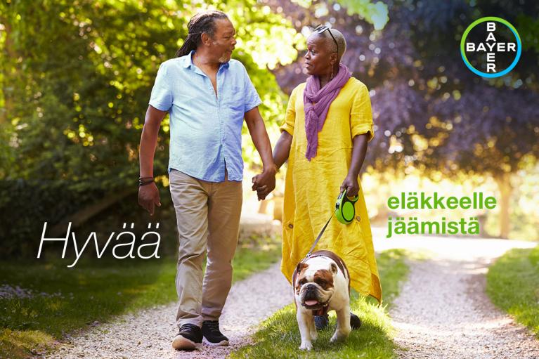 An elderly couple walks hand in hand down a gravel path with a bulldog. The words "Hyvää eläkkeelle jäämistä" are overlaid, and a Bayer logo is in the top right corner.