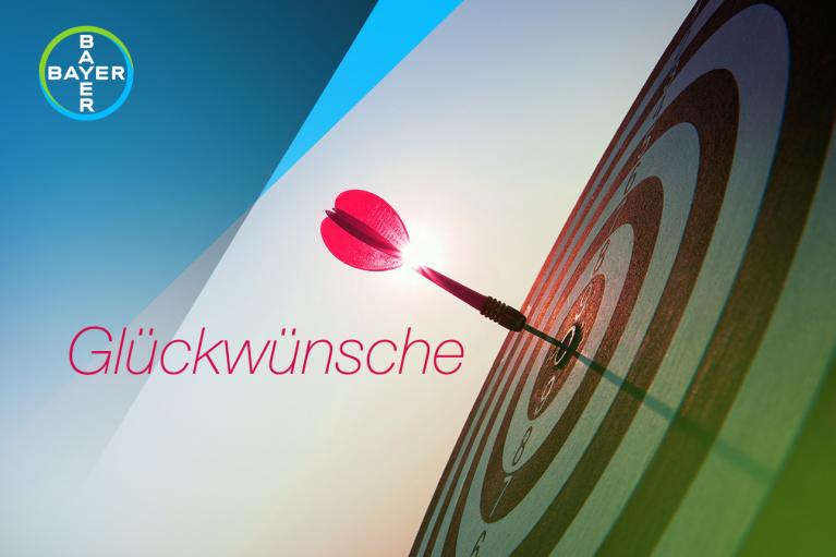 Target with a dart in the center and the word "Glückwünsche"