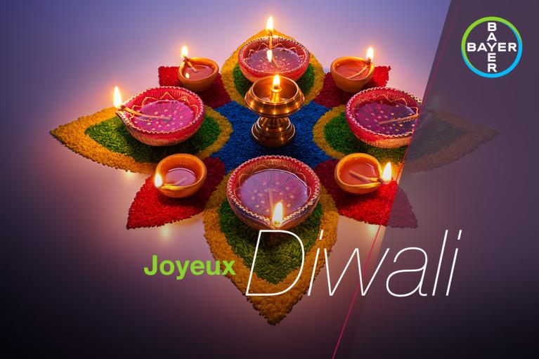 Joyeux Diwali, candles arranged in the shape of a lotus flower