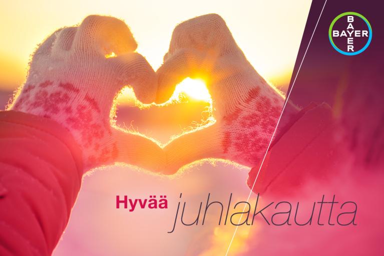 Hyvää  juhlakautta, Hands in gloves form heart in front of sunset