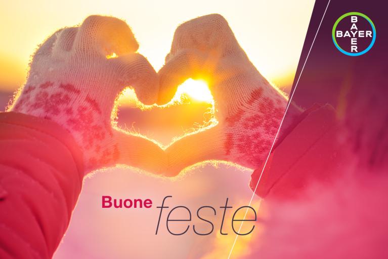 Buone feste, Hands in gloves form heart in front of sunset