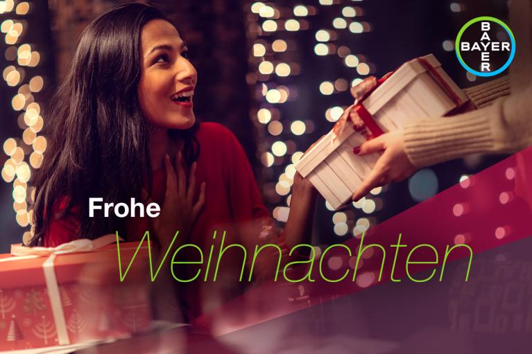 Frohe Weihnachten, woman gets Christmas gifts