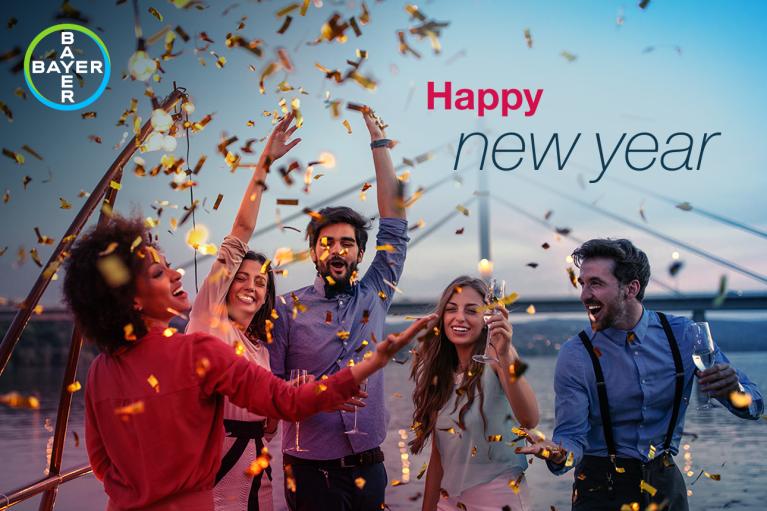 Happy new year, group of people throwing confetti in front of bridge