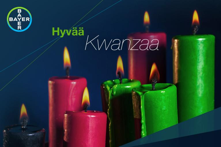 Hyvää Kwanzaaa, 1 black, 3 green and 3 red burning candles