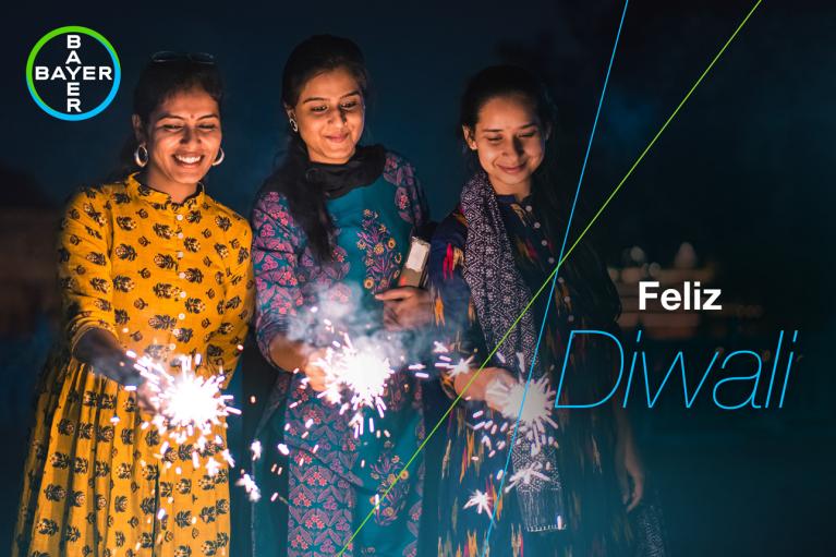 Feliz Diwali, three women with sparklers