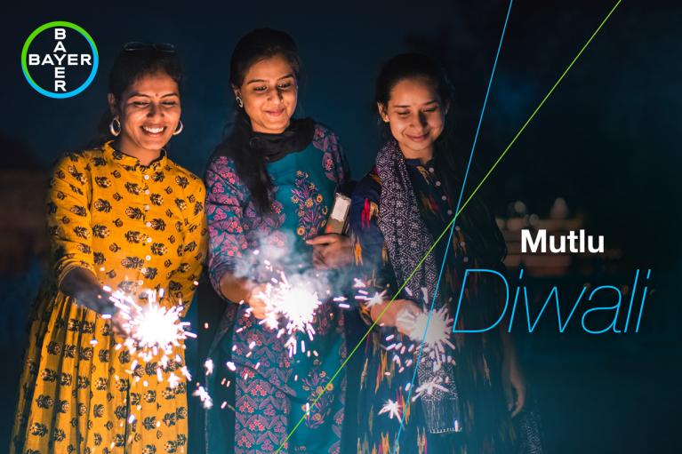 Mutlu Diwali, three women with sparklers