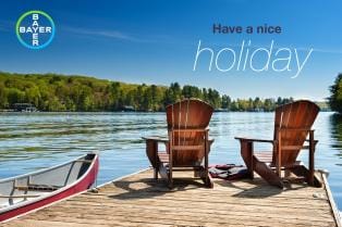 Two wooden chairs and a canoe on a lakeside dock with trees in the background. Text reads "Have a nice holiday." Bayer logo is visible.